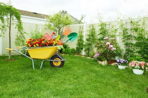 Professional hedge trimmer servicing a well-maintained hedge